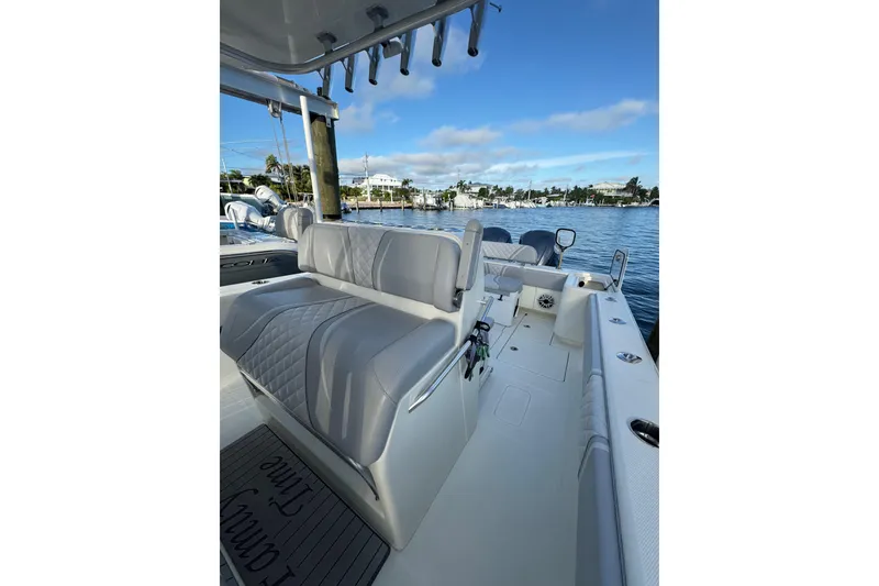Slide: The Image of 2022 SeaVee 322 Z boat interior with seating, docked by a scenic waterfront. - 19