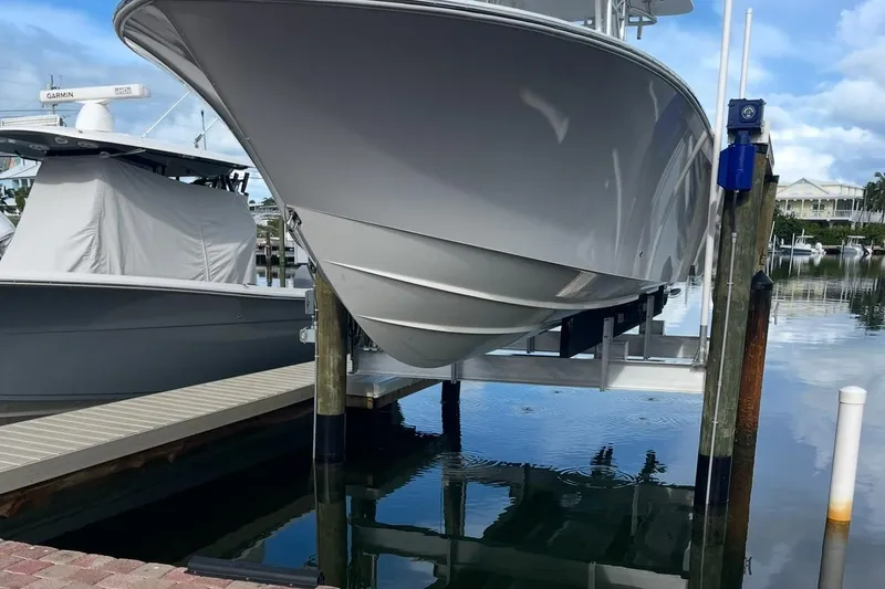 Slide: The Image of 2022 SeaVee 322 Z boat docked on a lift at a marina. - 2