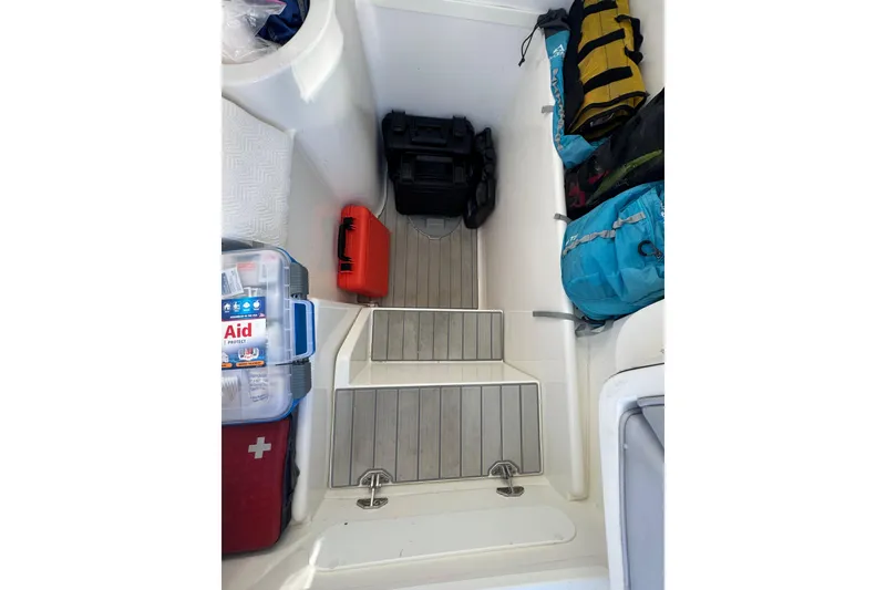 Slide: The Image of Interior storage of 2022 SeaVee 322 Z boat with gear and first aid kit. - 28