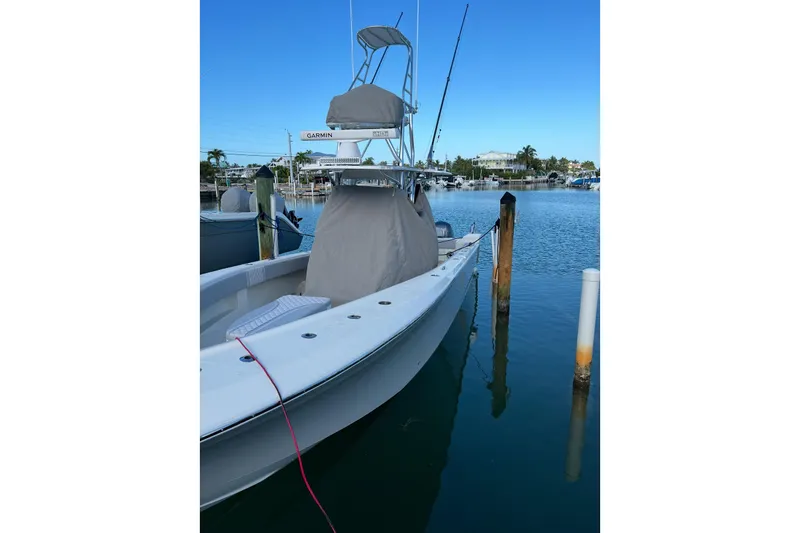 Slide: The Image of 2022 SeaVee 322 Z boat docked in a serene marina setting. - 4