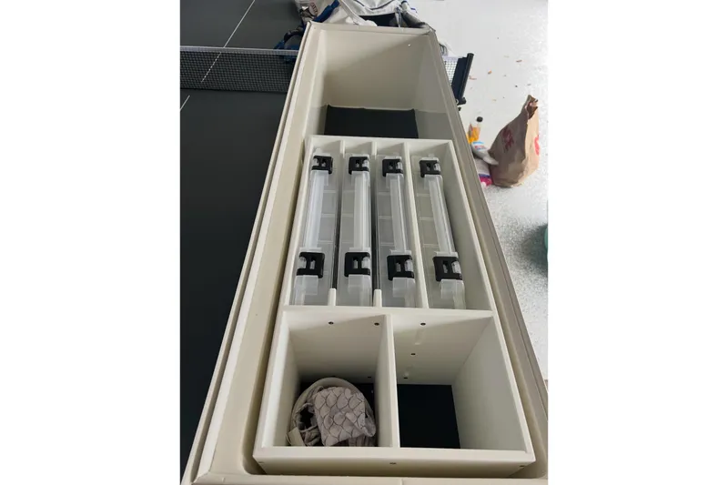 Slide: The Image of Storage compartments on a 2022 SeaVee 322 Z boat, featuring organized tackle boxes. - 7