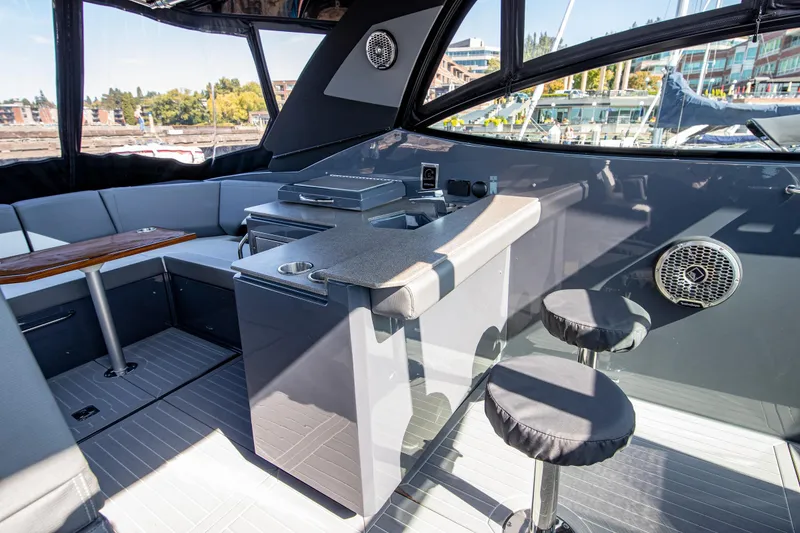 Slide: The Image of 2024 Cruisers Yachts 38 GLS OB interior with seating, bar area, and modern design. - 14