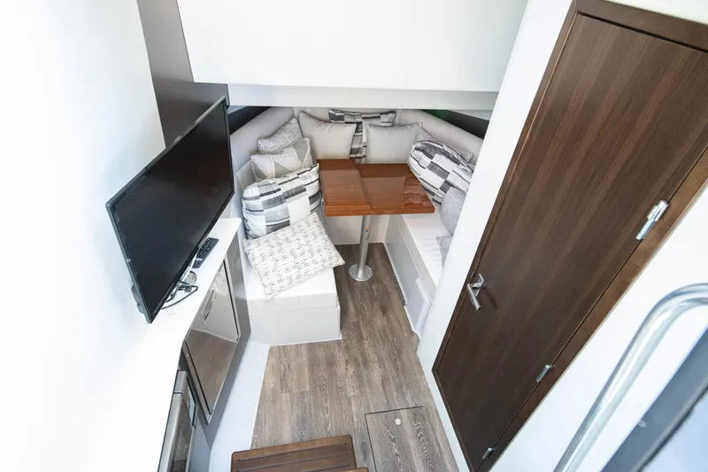 Slide: The Image of 2024 Cruisers Yachts 38 GLS OB interior with cozy seating and modern amenities. - 15