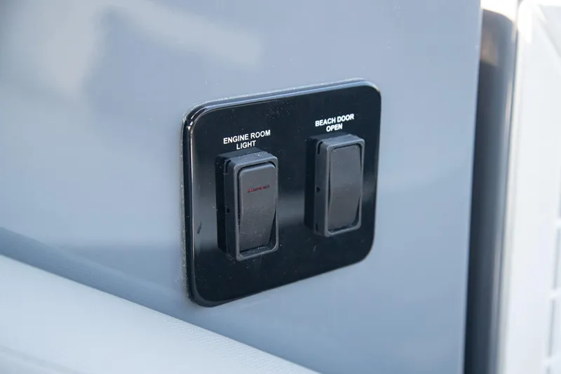 Slide: The Image of Control panel on 2024 Cruisers Yachts 38 GLS OB with engine room light and beach door switches. - 25