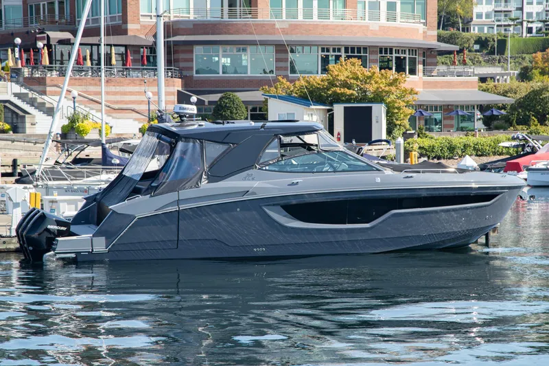 Slide: The Image of 2024 Cruisers Yachts 38 GLS OB docked at marina, modern design, waterfront background. - 30