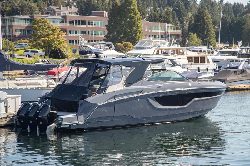 Slide: The Image of 2024 Cruisers Yachts 38 GLS OB docked in a marina, surrounded by other boats. - 32