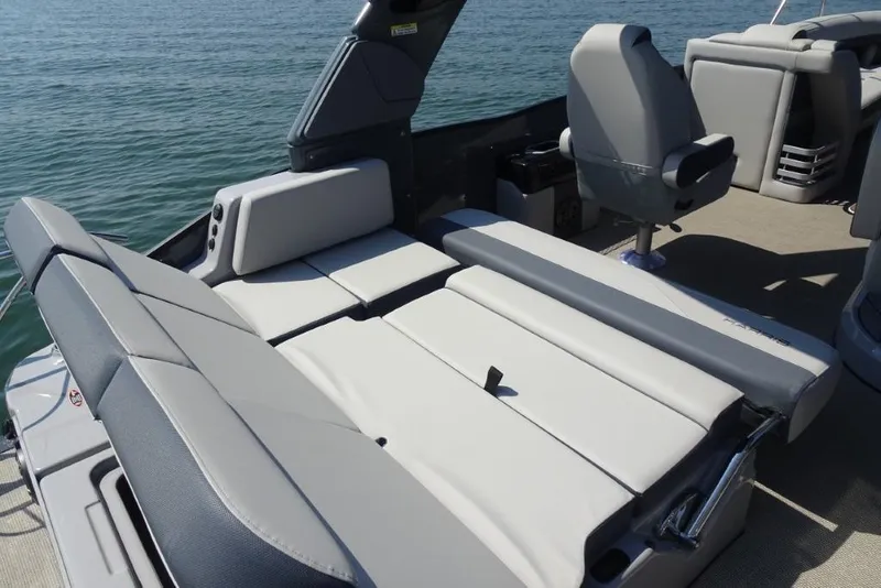 Slide: The Image of 2026 Harris Grand Mariner 250 boat interior with luxurious seating and modern design on the water. - 11