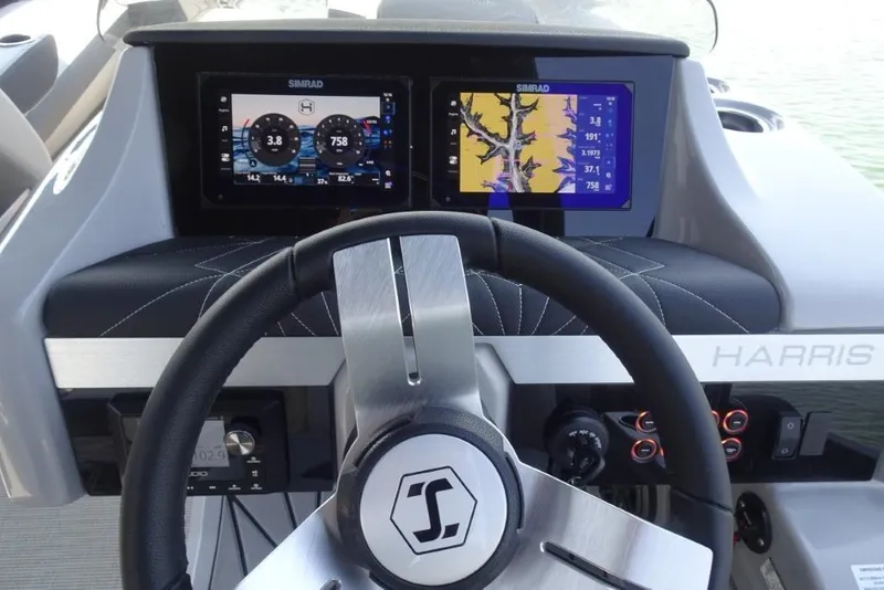 Slide: The Image of Steering wheel and dashboard of 2026 Harris Grand Mariner 250 boat with Simrad displays. - 15