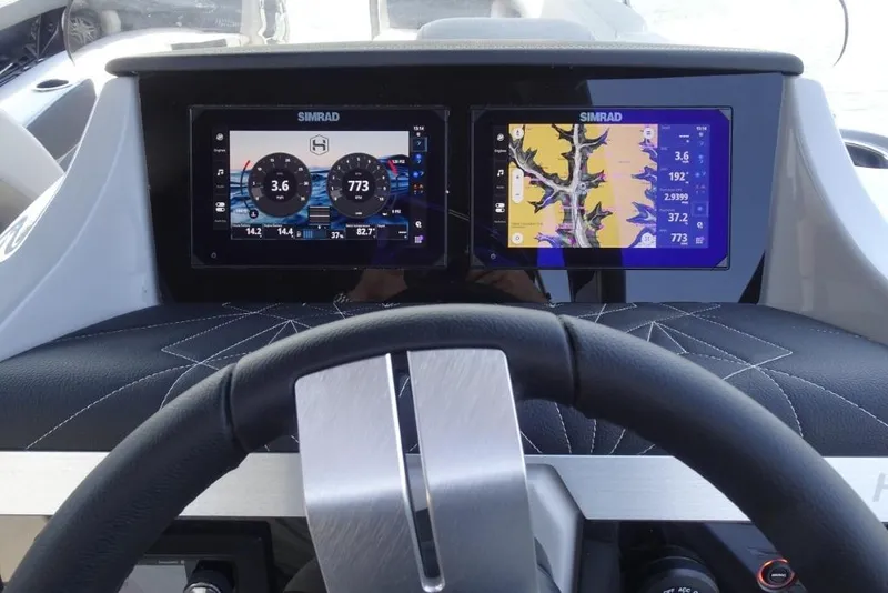 Slide: The Image of Steering wheel and dual Simrad displays on 2026 Harris Grand Mariner 250 boat dashboard. - 16