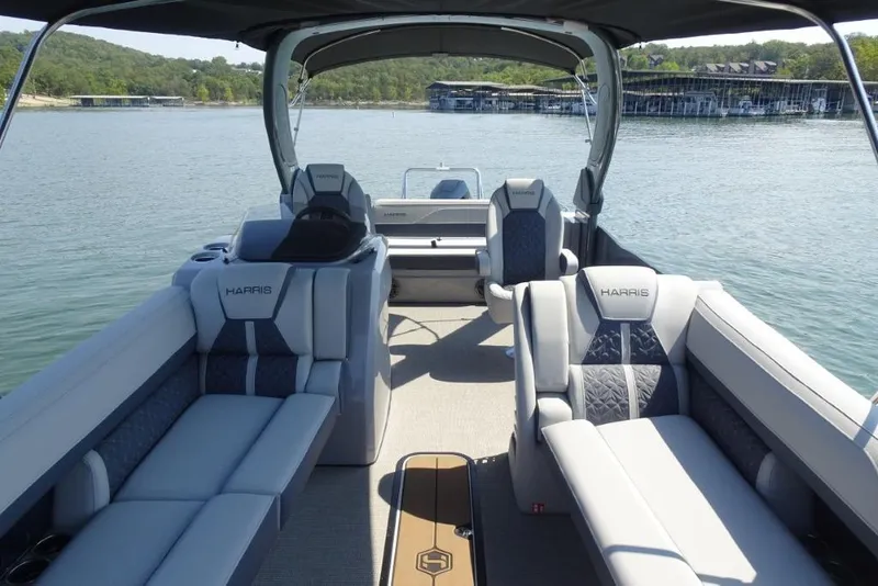 Slide: The Image of 2026 Harris Grand Mariner 250 pontoon boat interior on a serene lake. - 20