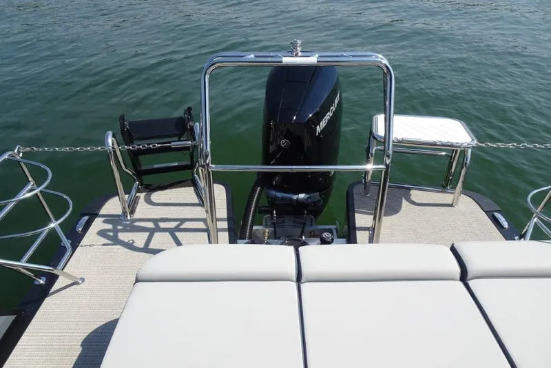 Slide: The Image of 2026 Harris Grand Mariner 250 boat with Mercury engine on calm water. - 26