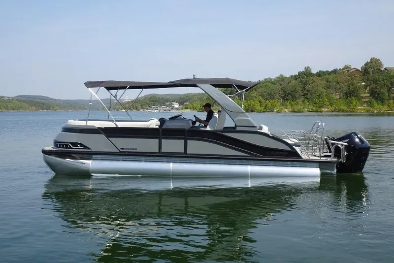 Slide: The Image of 2026 Harris Grand Mariner 250 pontoon boat on a serene lake. - 4