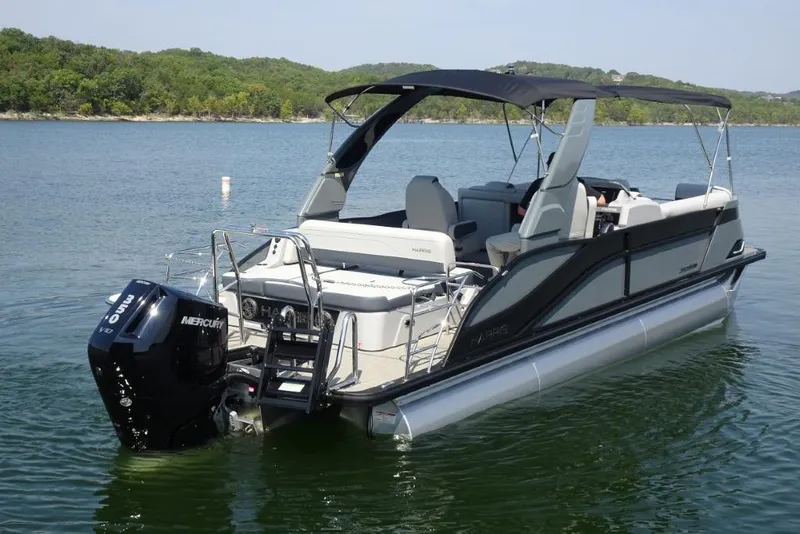 Slide: The Image of 2026 Harris Grand Mariner 250 pontoon boat on a serene lake. - 7