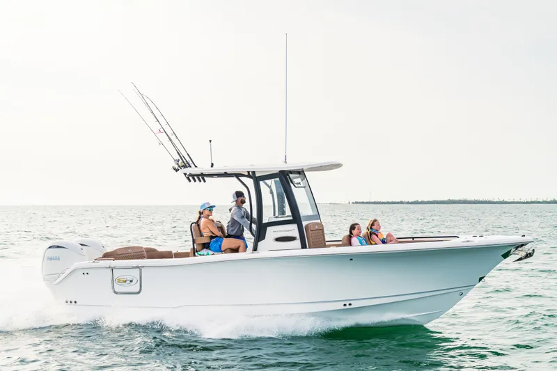 Slide: The Image of 2026 Sea Hunt Ultra 265 SE boat cruising on open water with passengers onboard. - 0