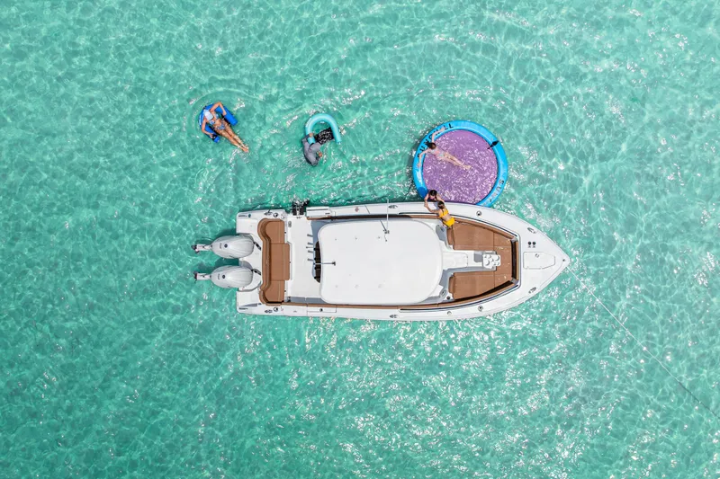 Slide: The Image of Aerial view of 2026 Sea Hunt Ultra 265 SE boat on clear turquoise water. - 1