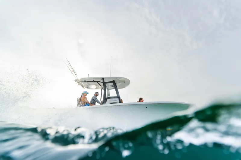 Slide: The Image of 2026 Sea Hunt Ultra 265 SE boat navigating through ocean waves. - 11