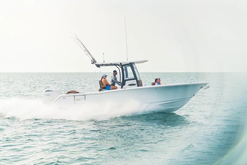 Slide: The Image of 2026 Sea Hunt Ultra 265 SE cruising on open water with passengers. - 12