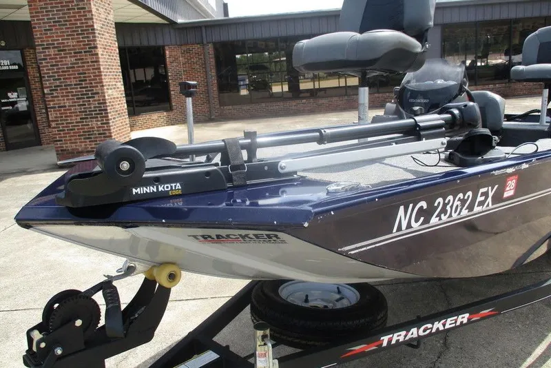 Slide: The Image of 2022 Tracker Pro 170 boat with Minn Kota Edge trolling motor, parked outside a building. - 3