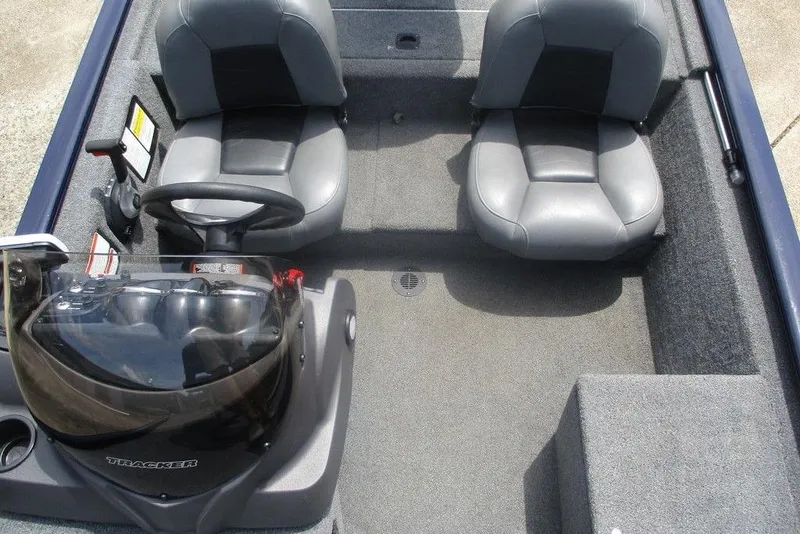 Slide: The Image of 2022 Tracker Pro 170 boat interior with two gray seats and steering console. - 5