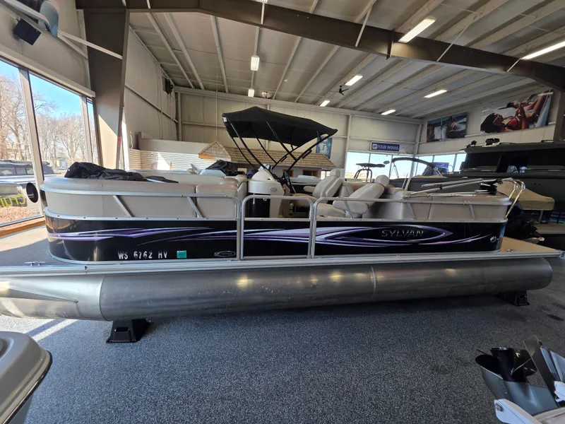 Slide: The Image of 2012 Sylvan 8524 Mirage LZ pontoon boat in a showroom. - 1