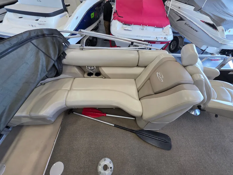 Slide: The Image of Interior of a 2012 Sylvan 8524 Mirage LZ boat with beige seating. - 4