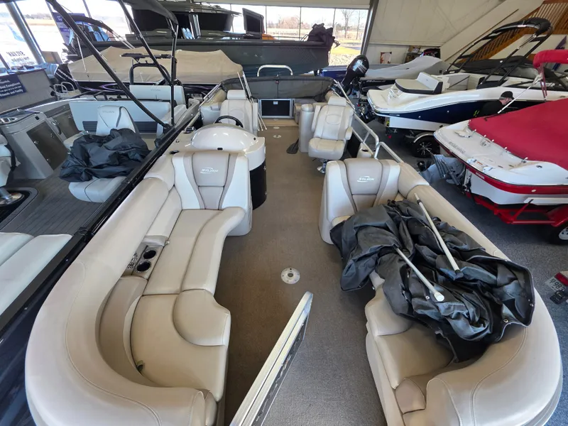 Slide: The Image of Interior view of a 2012 Sylvan 8524 Mirage LZ pontoon boat in showroom. - 8