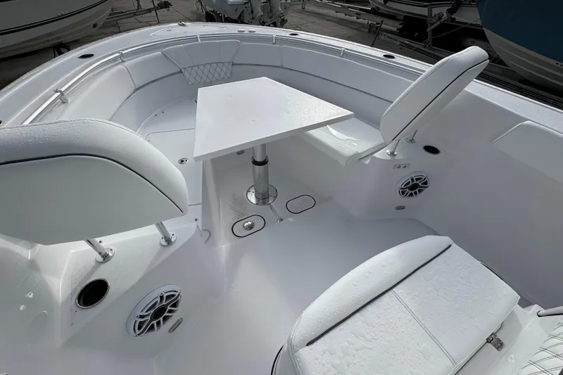 Slide: The Image of 2026 Sportsman Heritage 261 Center Console boat interior with seating and table. - 13