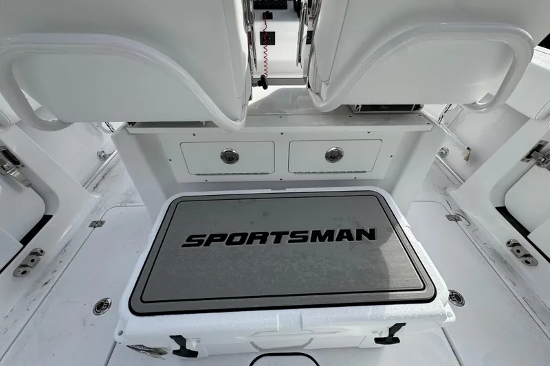 Slide: The Image of 2026 Sportsman Heritage 261 Center Console boat interior with storage and seating. - 6