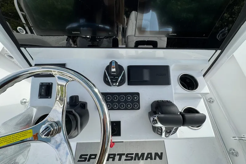 Slide: The Image of 2026 Sportsman Heritage 261 Center Console dashboard with steering wheel and controls. - 9
