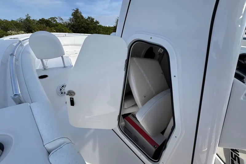 Slide: The Image of 2026 Sportsman Heritage 231 Center Console boat with open storage compartment. - 12
