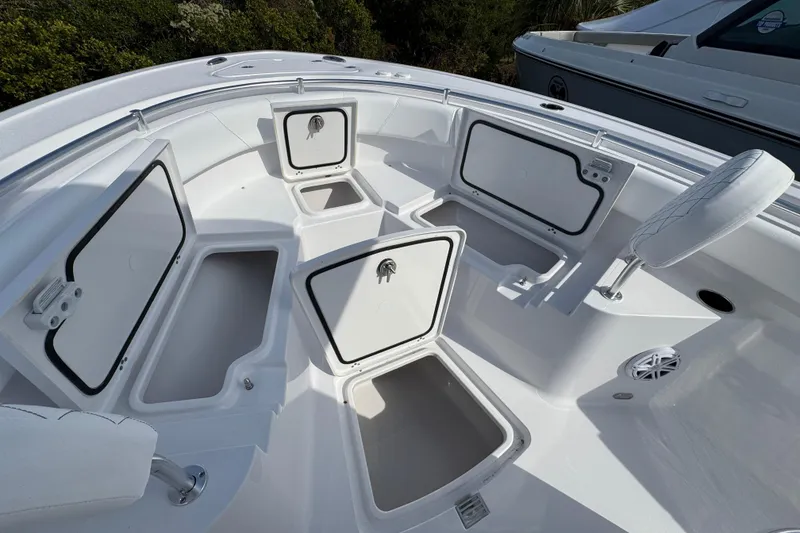Slide: The Image of 2026 Sportsman Heritage 231 Center Console boat with open storage compartments. - 14