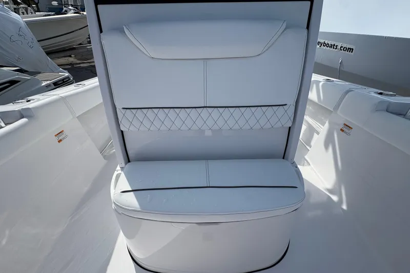 Slide: The Image of 2026 Sportsman Heritage 231 Center Console boat interior with cushioned seating. - 16