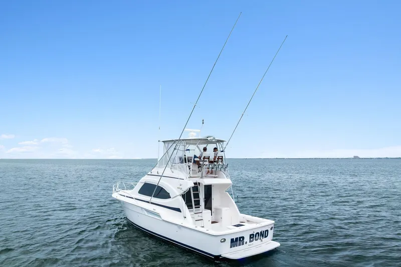 Slide: The Image of 2006 Bertram 39 Convertible yacht on open water under clear blue sky. - 16