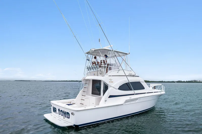 Slide: The Image of 2006 Bertram 39 Convertible yacht on open water under clear blue sky. - 17