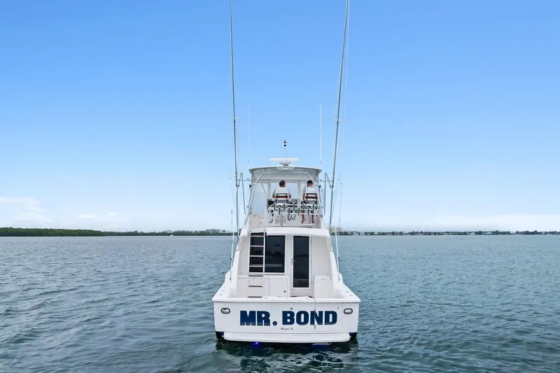 Slide: The Image of 2006 Bertram 39 Convertible boat named "Mr. Bond" on calm waters. - 18
