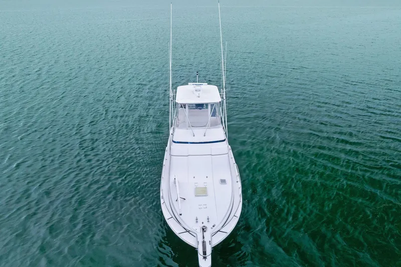 Slide: The Image of 2006 Bertram 39 Convertible yacht on calm ocean waters, aerial view. - 20
