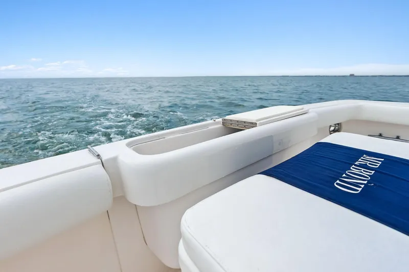 Slide: The Image of 2006 Bertram 39 Convertible boat on open sea, featuring white seating and blue cushion. - 22