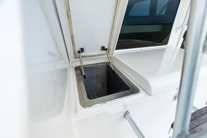Slide: The Image of Open storage compartment on 2006 Bertram 39 Convertible boat deck. - 26