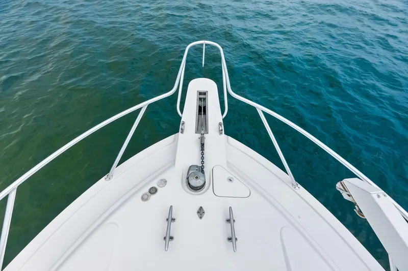 Slide: The Image of Bow of 2006 Bertram 39 Convertible yacht on clear blue water. - 29