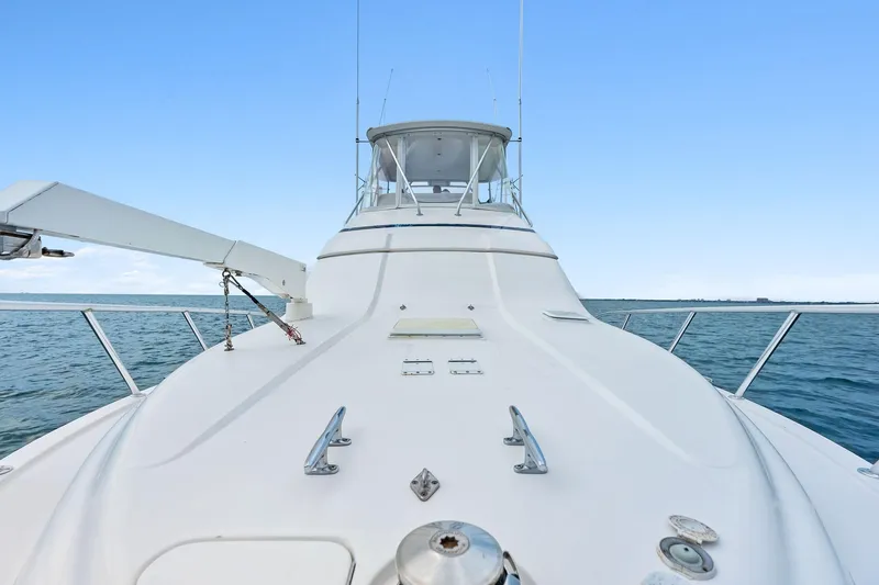 Slide: The Image of 2006 Bertram 39 Convertible yacht on open water, showcasing sleek deck design. - 32