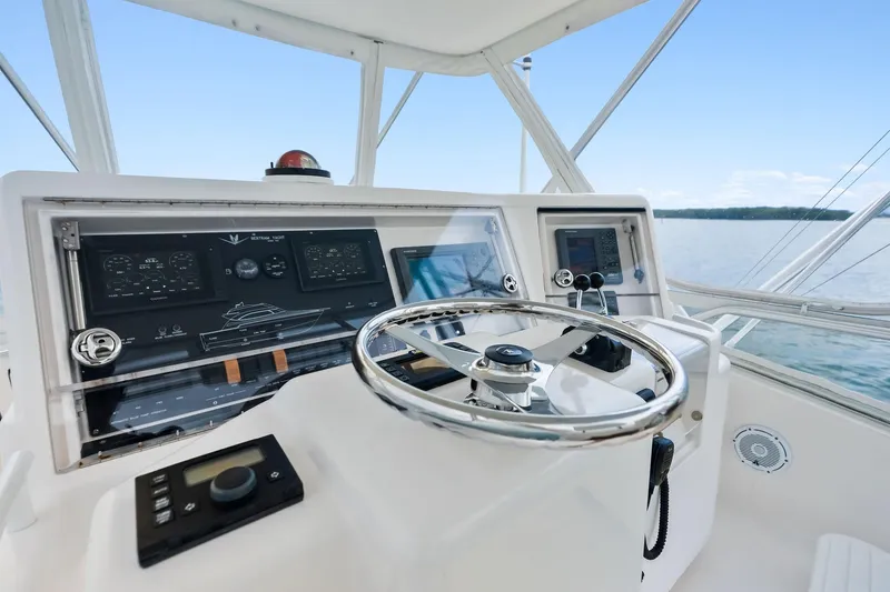 Slide: The Image of 2006 Bertram 39 Convertible yacht helm with steering wheel and navigation controls. - 37
