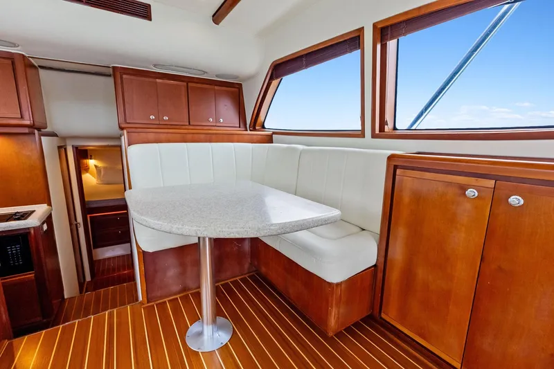 Slide: The Image of Interior of 2006 Bertram 39 Convertible yacht with wooden cabinetry and white seating. - 44