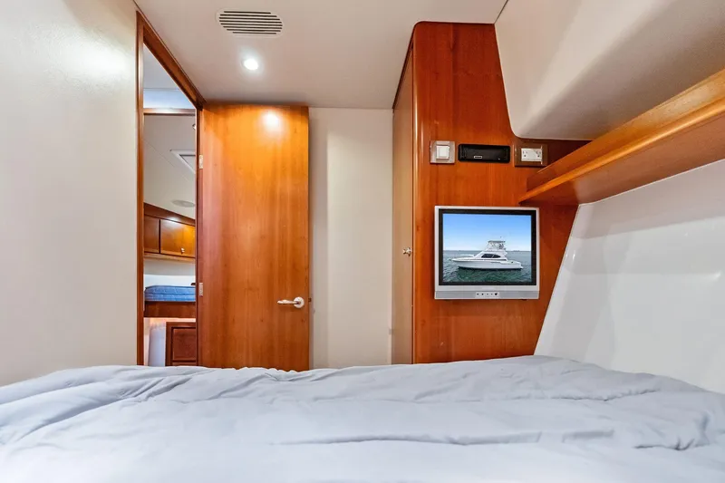 Slide: The Image of Interior of 2006 Bertram 39 Convertible yacht with wood paneling and TV. - 51