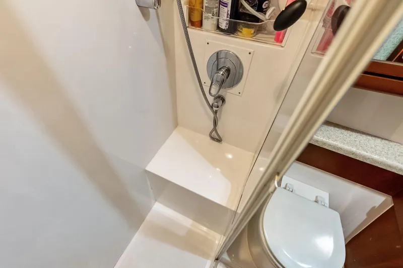 Slide: The Image of Bathroom interior of 2006 Bertram 39 Convertible yacht, featuring shower and toilet. - 52