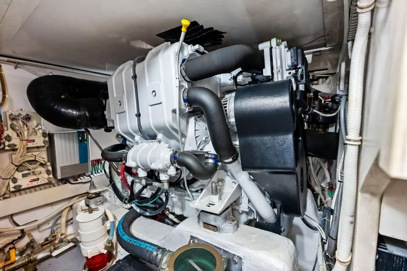 Slide: The Image of Engine room of 2006 Bertram 39 Convertible yacht, showcasing complex machinery and components. - 54