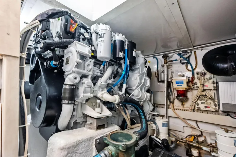 Slide: The Image of Engine room of a 2006 Bertram 39 Convertible yacht, showcasing detailed machinery. - 55