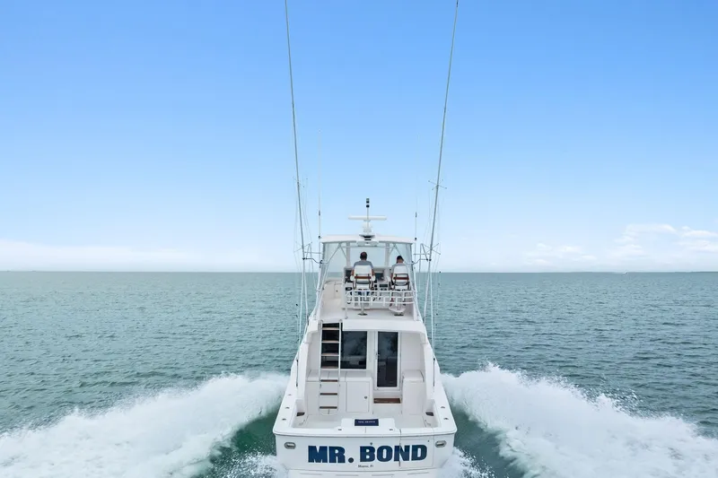 Slide: The Image of 2006 Bertram 39 Convertible yacht cruising on open sea, rear view. - 6