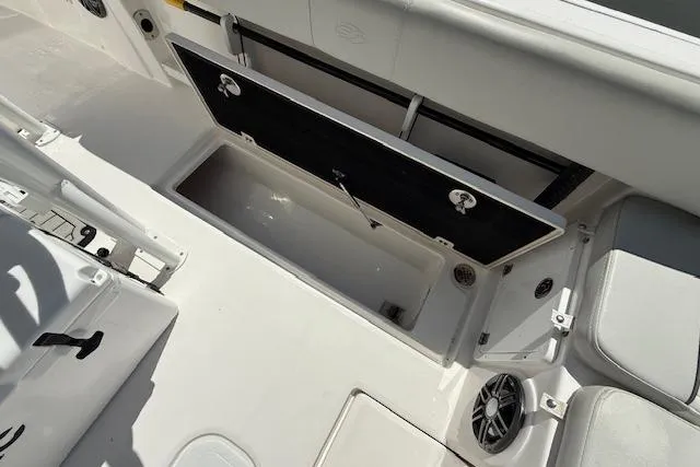 Slide: The Image of 2023 Sea Fox 268 Commander boat storage compartment with open hatch and seating area. - 17