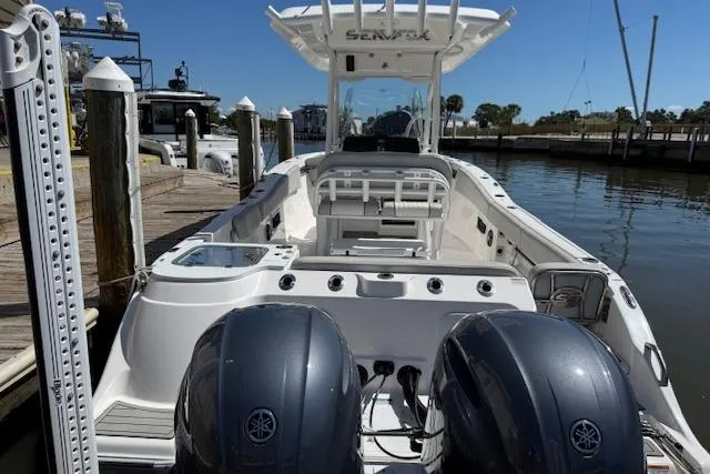 Slide: The Image of 2023 Sea Fox 268 Commander boat docked with dual Yamaha engines. - 2