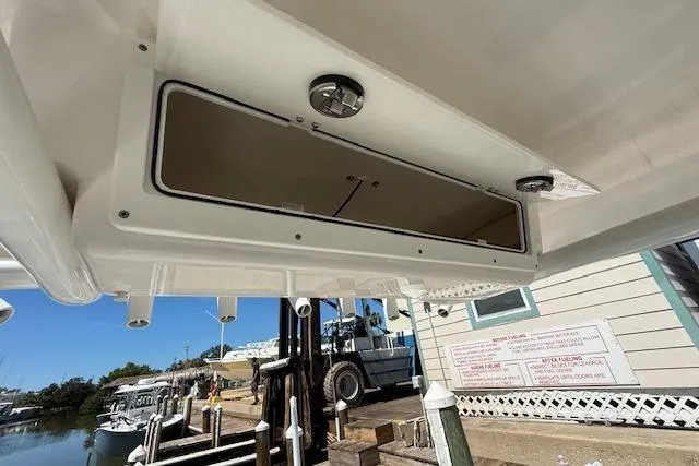 Slide: The Image of 2023 Sea Fox 268 Commander boat storage compartment, dockside view with clear sky. - 23